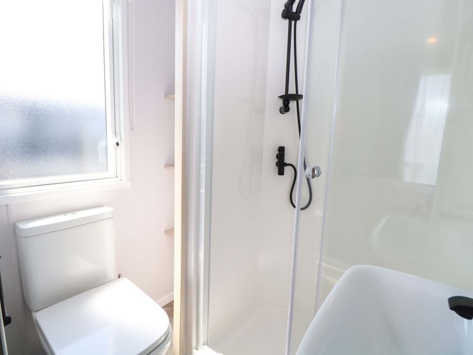 A bathroom with a shower and toilet at Sandy Shores Retreat in Norwich