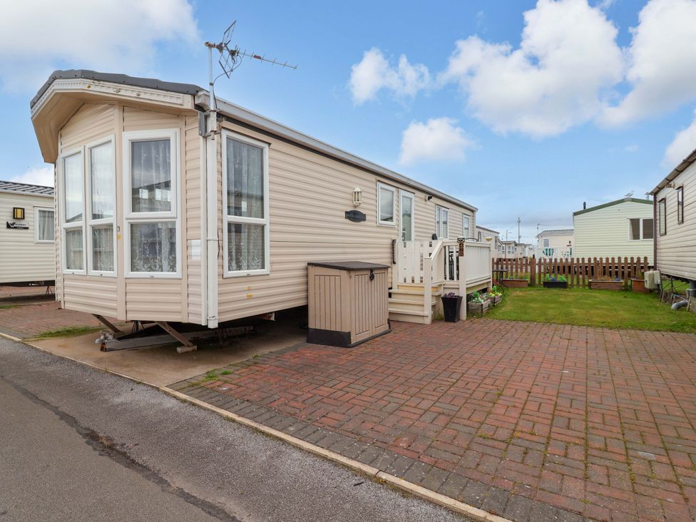 A caravan with steps and a fenced garden at Winchester - 478 Abergele