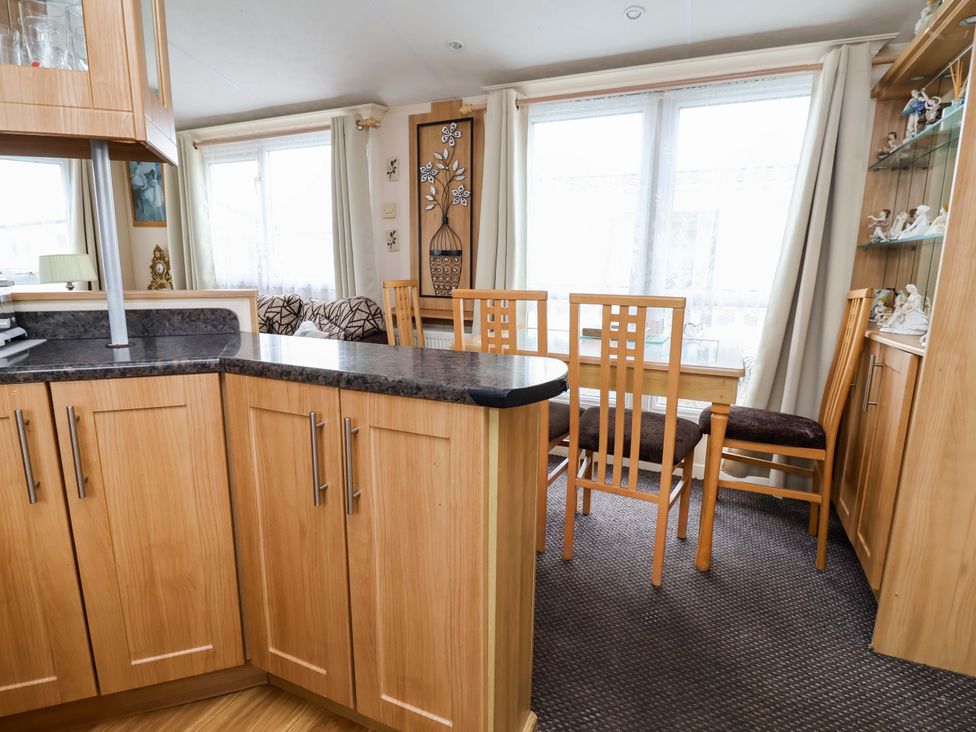 A dining room with a table and chairs at Winchester - 478 Abergele