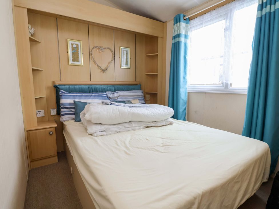 A bedroom with a bed and shelves at Winchester - 478 Abergele