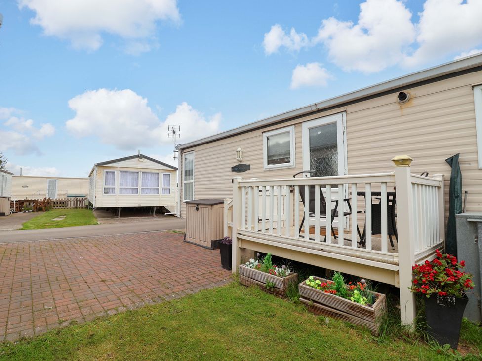 An outdoor area with a deck and caravan at Winchester - 478 Abergele
