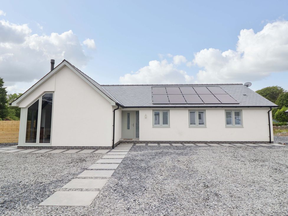 A house with solar panels and a gravel pathway at Kingfisher 
