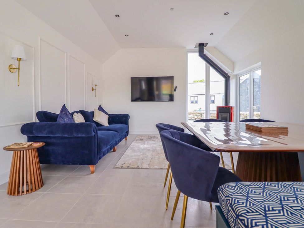 A living room with a sofa and television at Kingfisher
