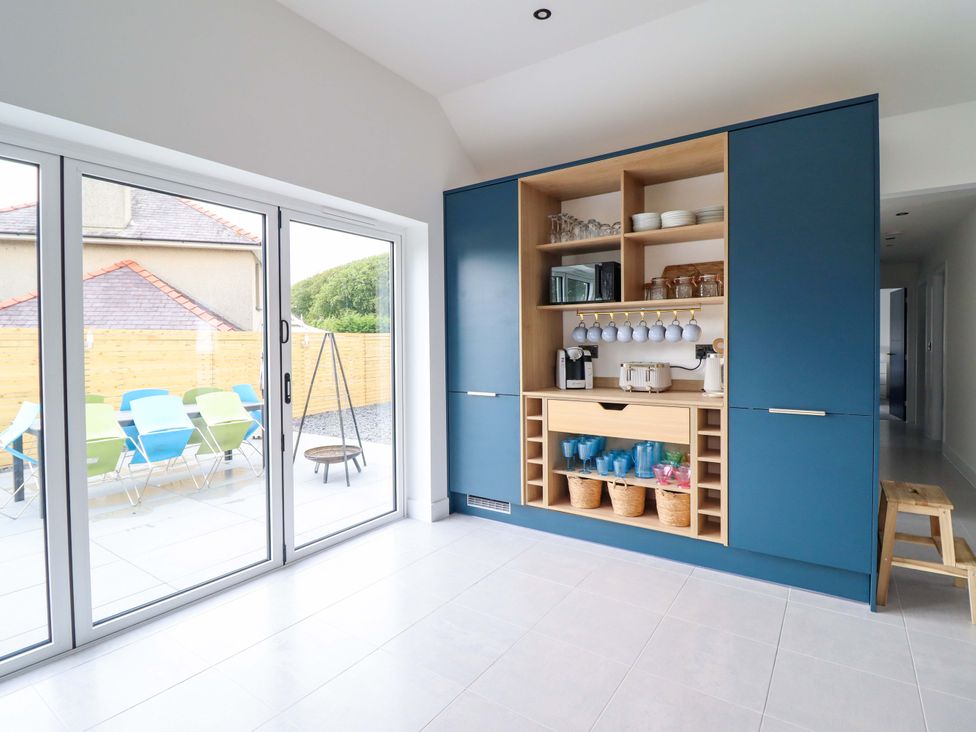 A kitchen with blue cabinets and kitchen appliances at Kingfisher