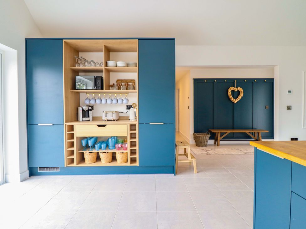 A kitchen with storage unit and appliances at Kingfisher
