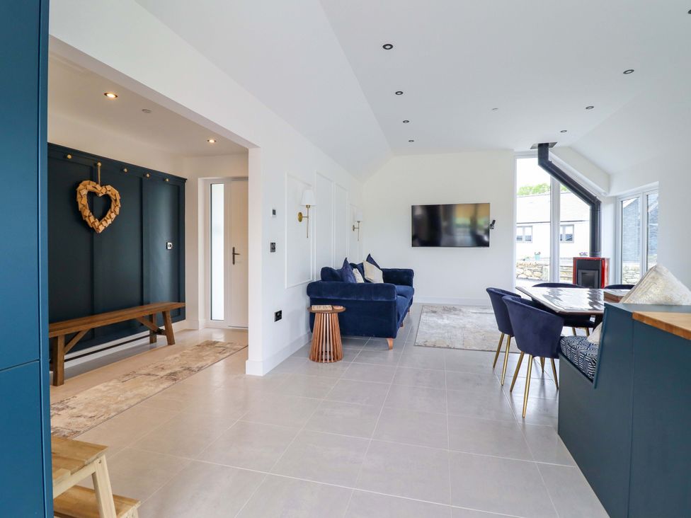 A living room with a sofa, coffee table and television at Kingfisher