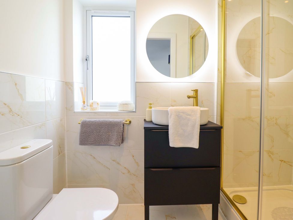 A bathroom with a sink and shower at Kingfisher 