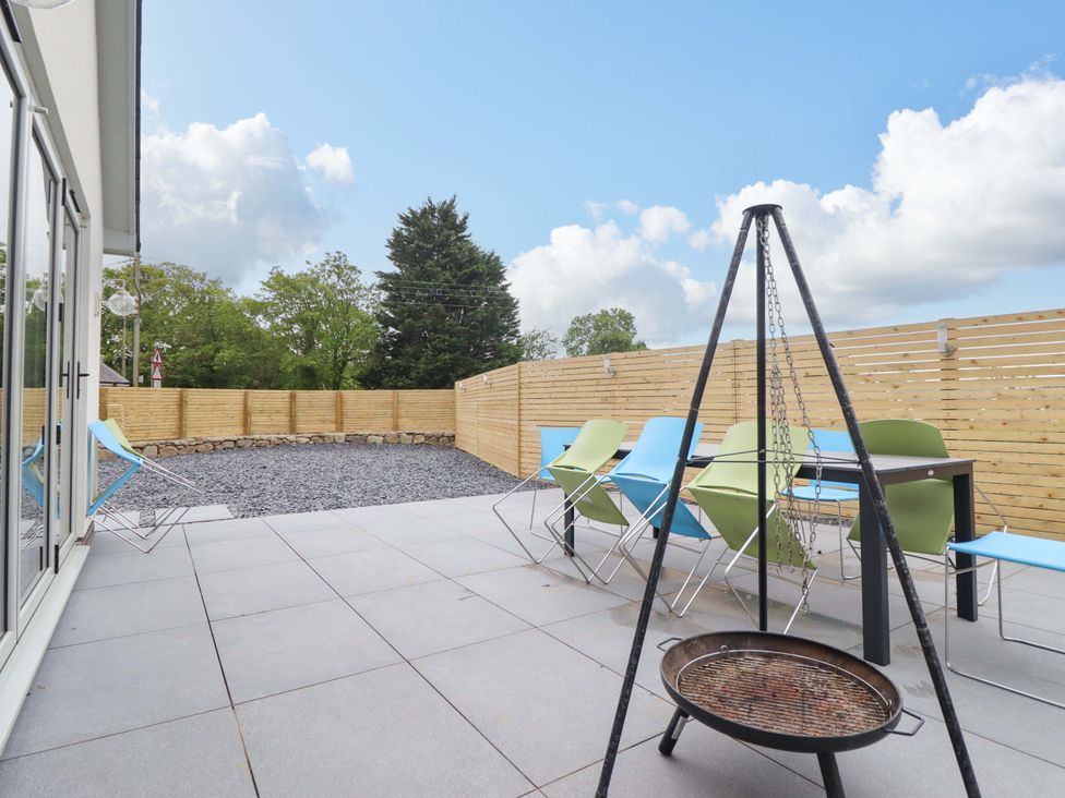 An outdoor patio with chairs and a grill at Kingfisher