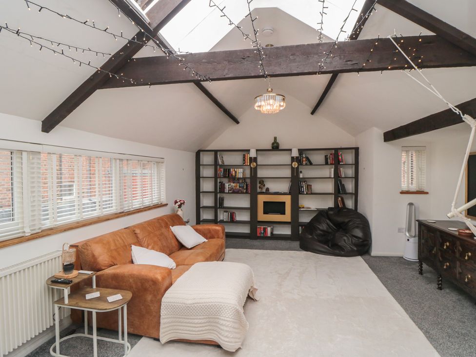A living room with a sofa and bookshelf at The Joinery in Scarborough
