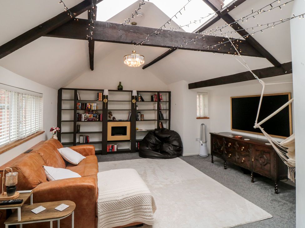 A living room with a sofa and bookshelf at The Joinery in Scarborough
