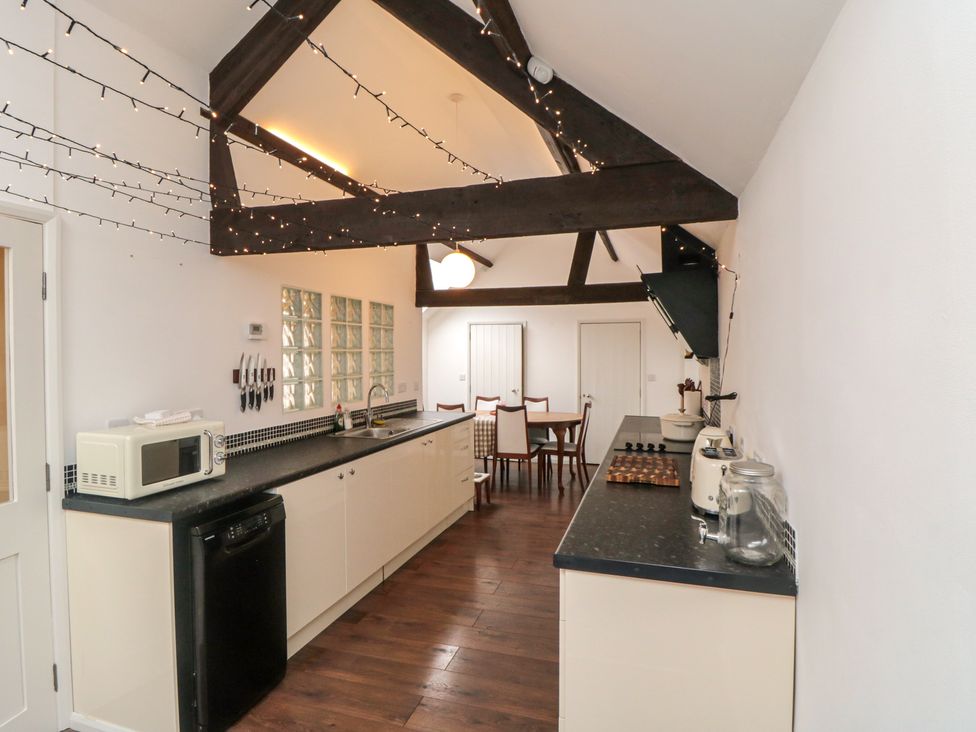 A kitchen with appliances and dining table at The Joinery in Scarborough