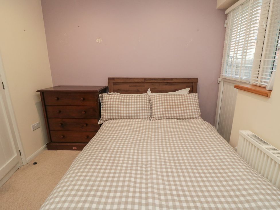 A bedroom with a bed and a dresser at The Joinery in Scarborough