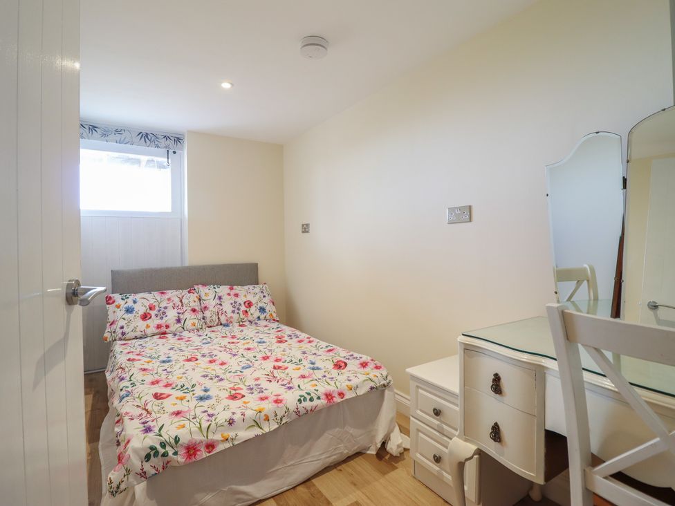 A bedroom with a bed and a desk at Hay Loft at Ebenezer Chapel Milwr