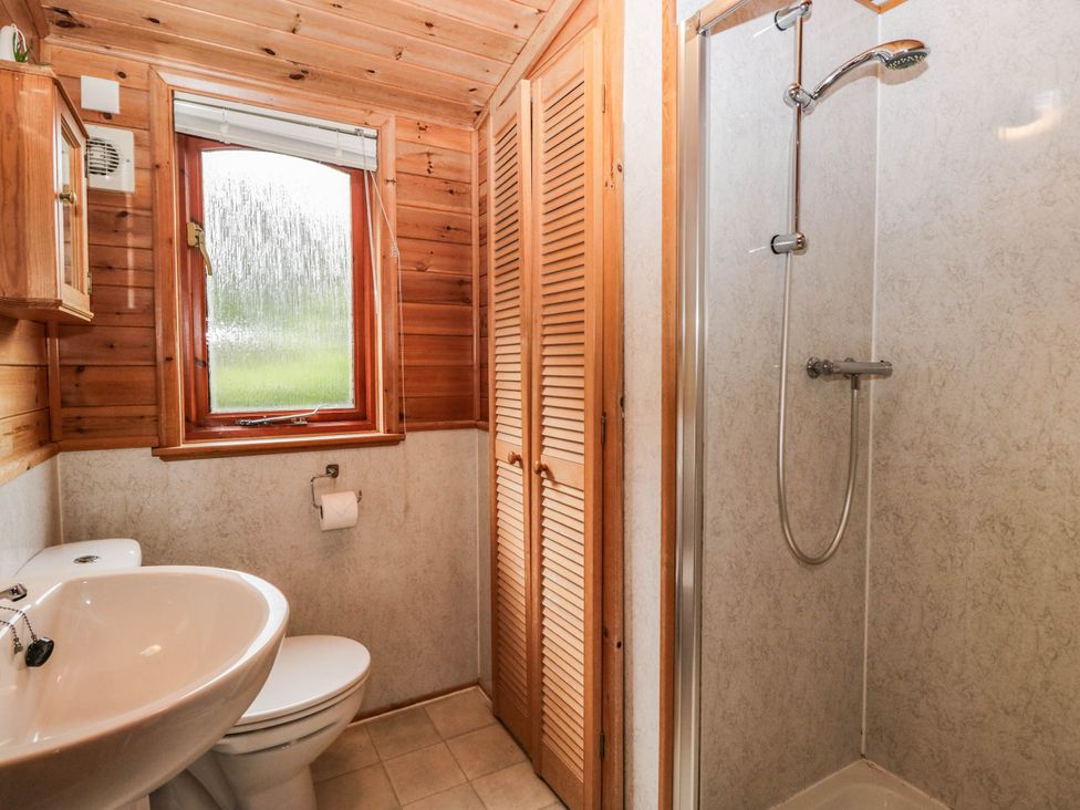 A bathroom with a sink, toilet, and shower at 89 Ambleside White Cross Bay