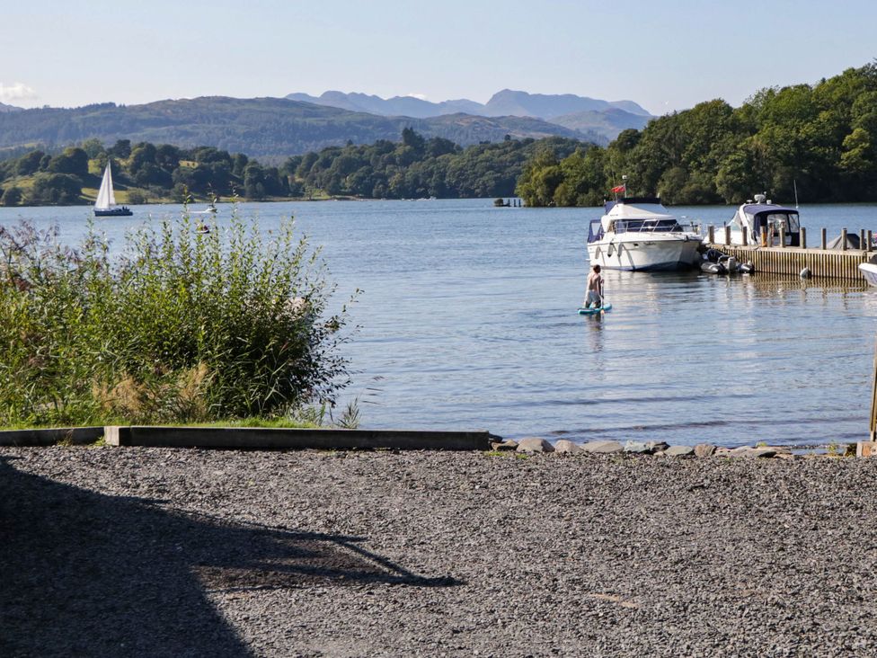 A person paddleboarding near boats at 89 Ambleside in White Cross Bay