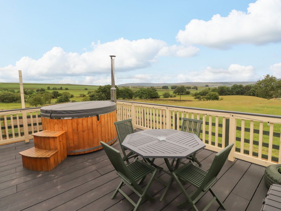 A patio area with a hot tub and seating at The View in Ilkley