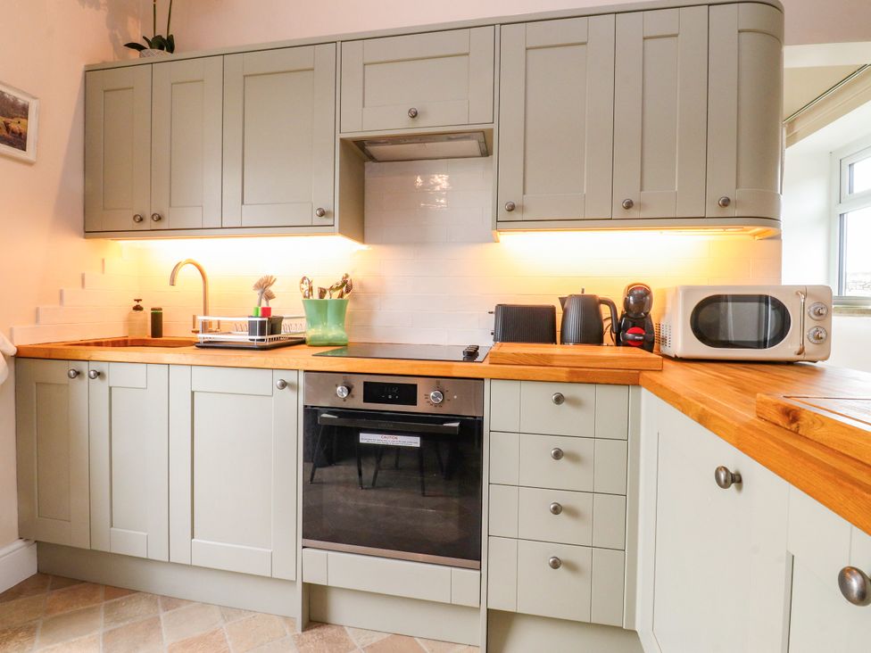 A kitchen with cabinets countertop and appliances at The View Ilkley