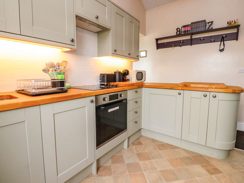 A kitchen with cabinets and appliances at The View in Ilkley