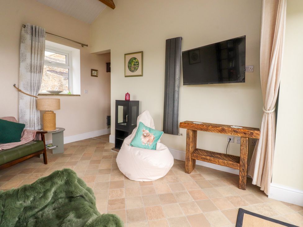 A living room with a sofa and tv at The View in Ilkley