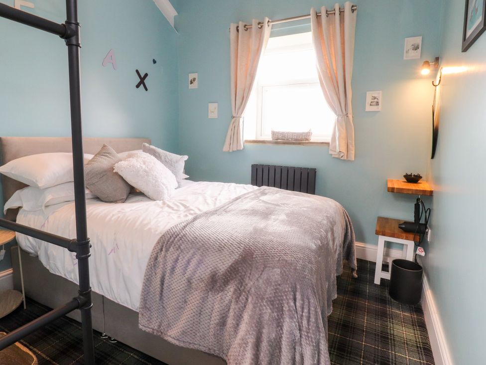 A bedroom with a bed and window at The View in Ilkley