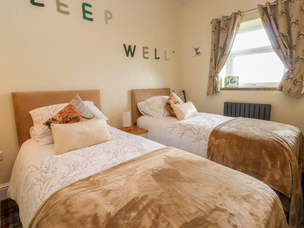 A bedroom with two beds and decorative pillows at The View in Ilkley