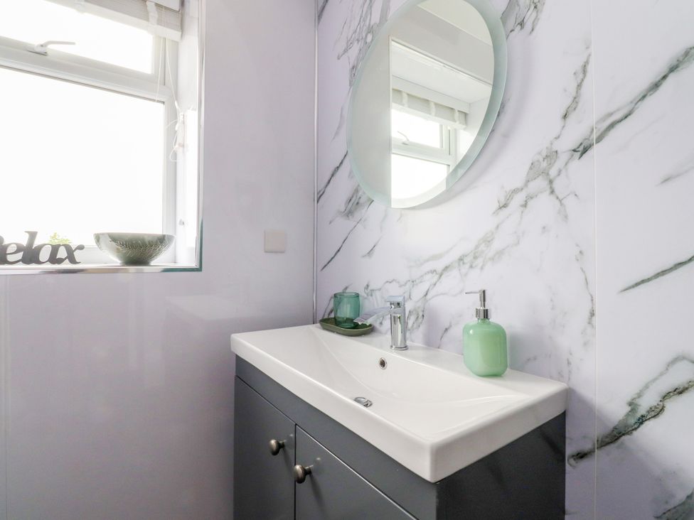 A bathroom with sink, mirror and window at The View in Ilkley