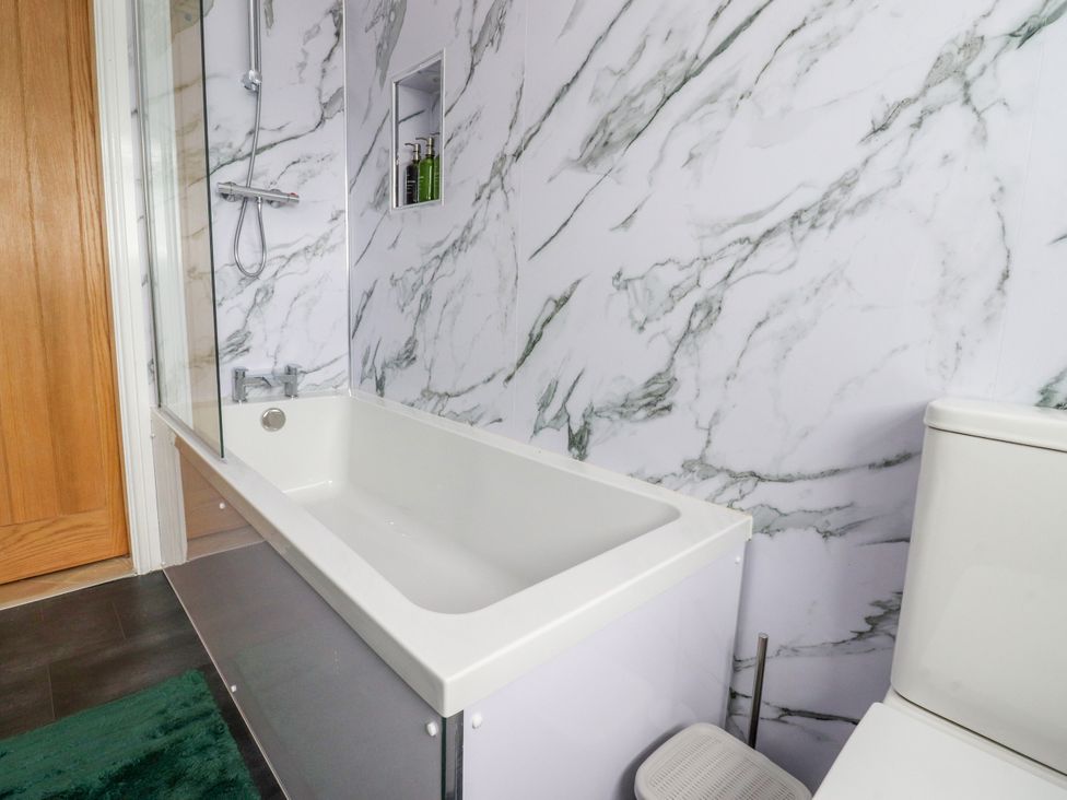 A bathroom with a bathtub and toilet at The View in Ilkley
