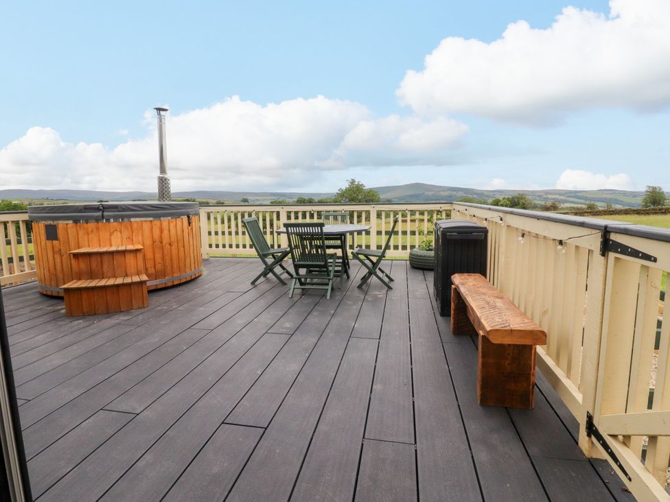 A deck with a hot tub and seating area at The View in Ilkley