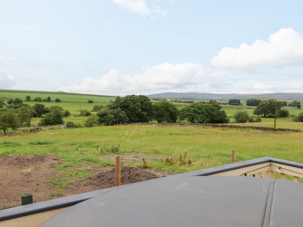A large field with trees and a fence at The View in Ilkley