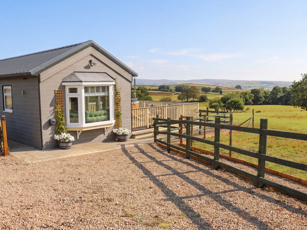 A house with a deck and fence at The View near Addingham