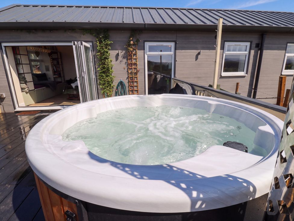 A hot tub on a wooden deck at The View near Addingham