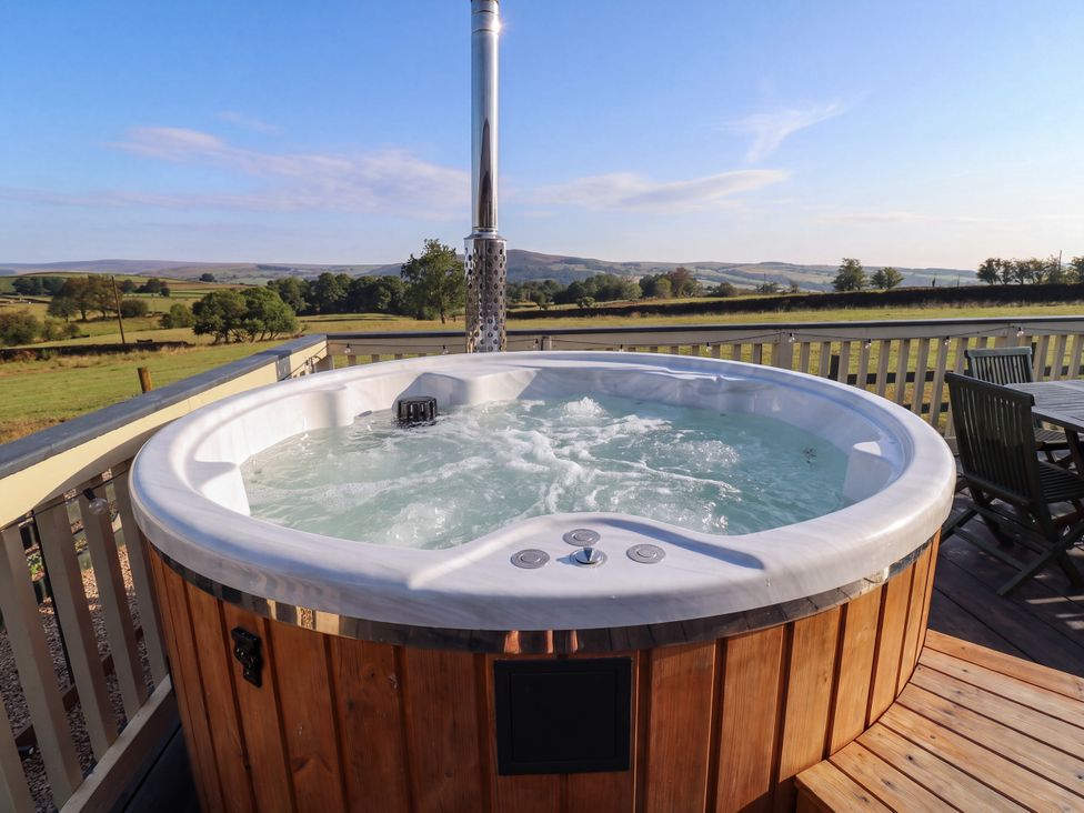 A hot tub with water and a view at The View near Addingham