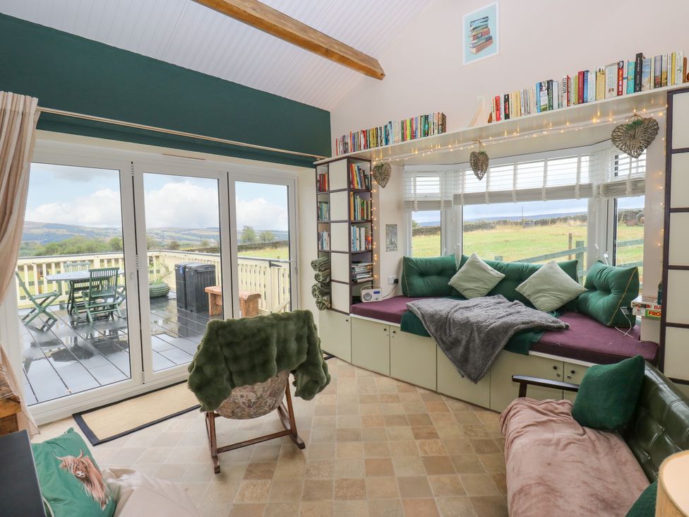 A snug with bookshelves and a seating area at The View near Addingham
