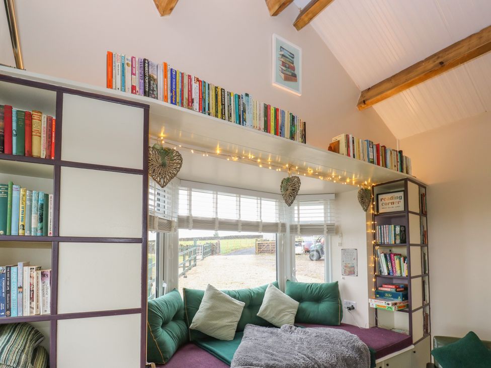 A snug area with bookshelves and seating at The View near Addingham