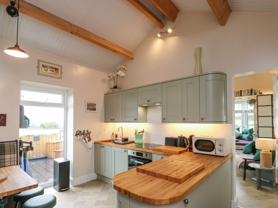 A kitchen with cabinets, island, and appliances at The View near Addingham