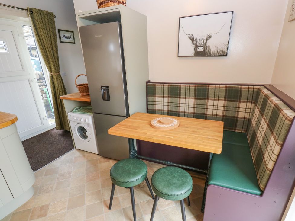 A kitchen with a dining area featuring a table and stools at The View near Addingham
