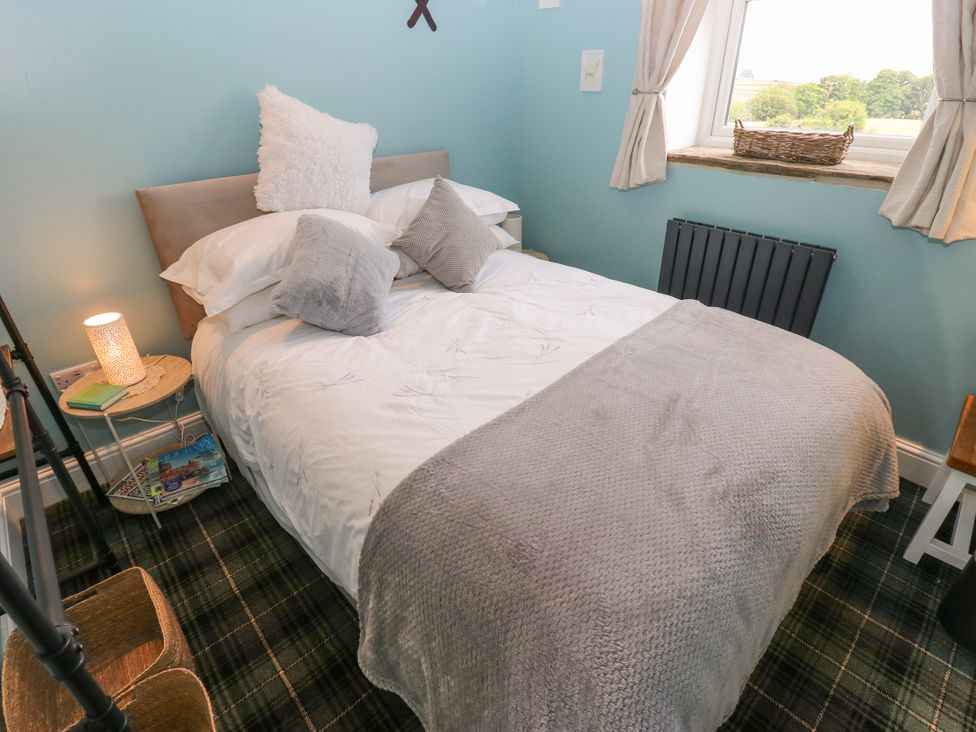 A bedroom with a bed and furniture at The View near Addingham