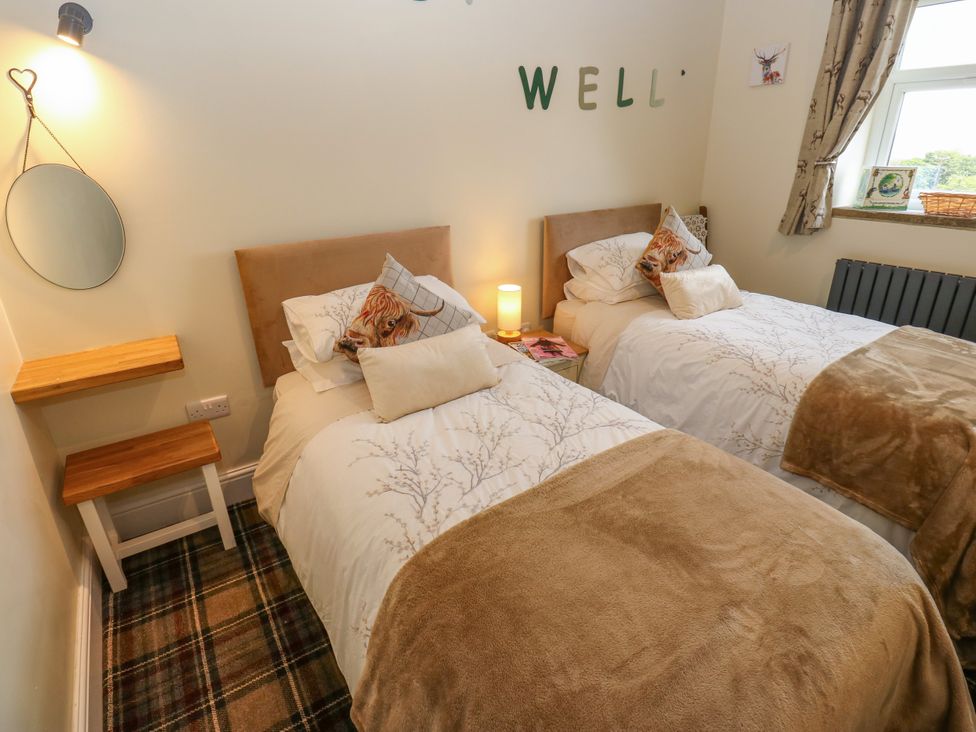 A bedroom with two beds and a window at The View near Addingham