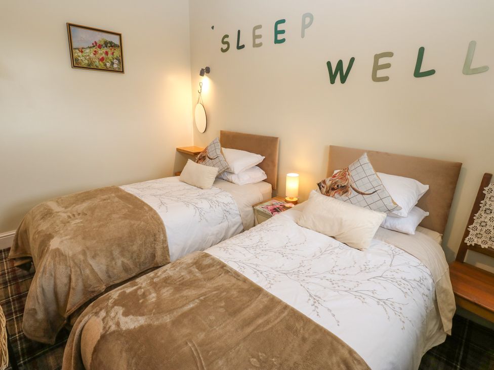 A bedroom with twin beds and a bedside table at The View near Addingham