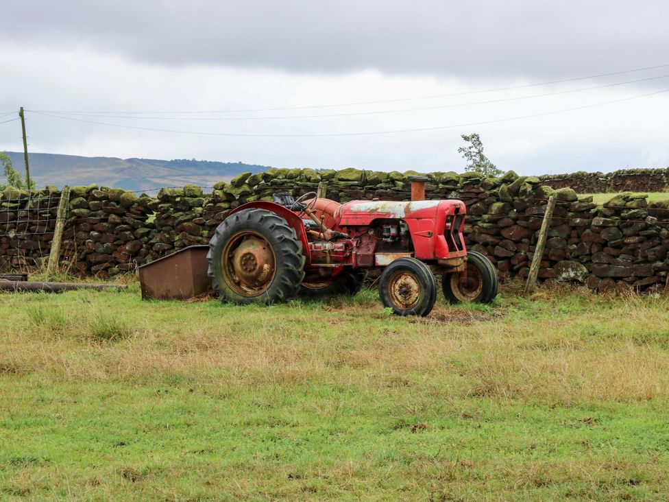 A tractor near a stone wall in a field at The View near Addingham