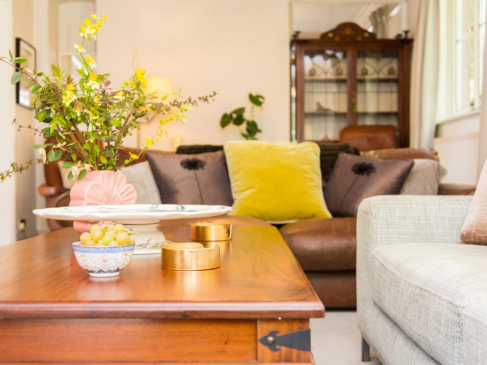 A living room with a coffee table and cushions at Whitebeams in Pett Bottom near Stelling Minnis