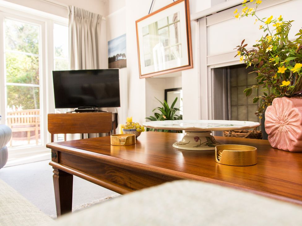 A living room featuring a coffee table and a television at Whitebeams Pett Bottom near Stelling Minnis