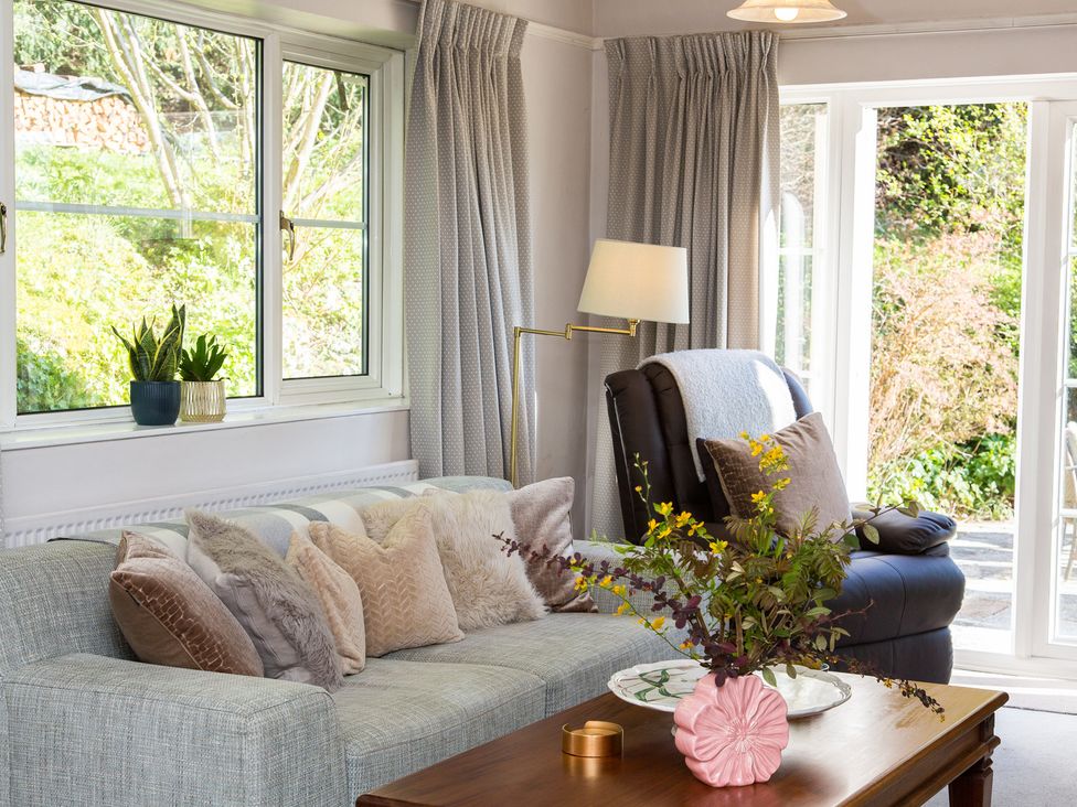 A living room with a sofa and windows at Whitebeams in Pett Bottom near Stelling Minnis