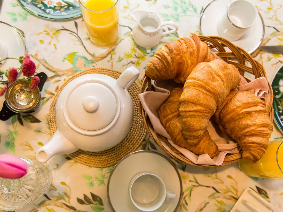 A dining table with croissants and tea at Whitebeams in Pett Bottom near Stelling Minnis