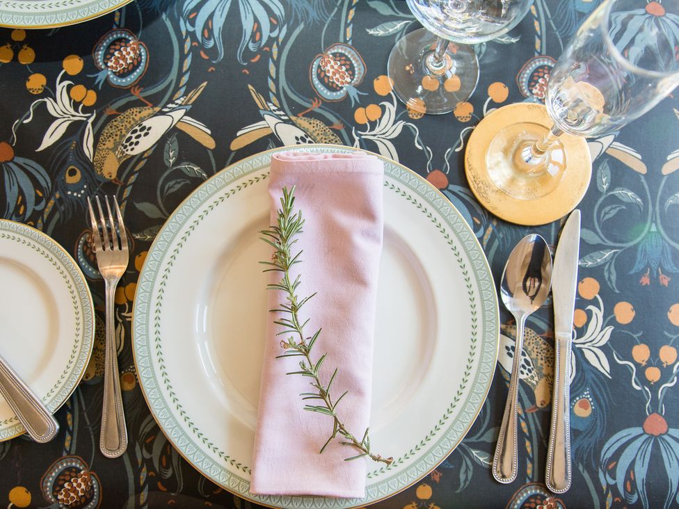A dining table setting with plates and glassware at Whitebeams Pett Bottom near Stelling Minnis