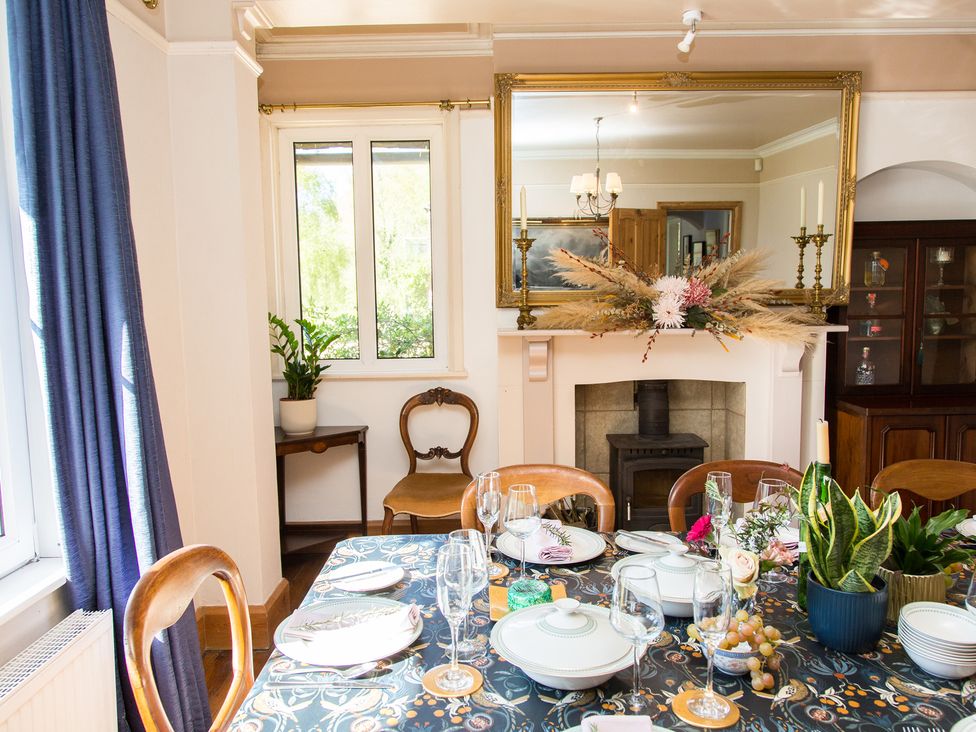 A dining room with a table set for a meal at Whitebeams Pett Bottom near Stelling Minnis
