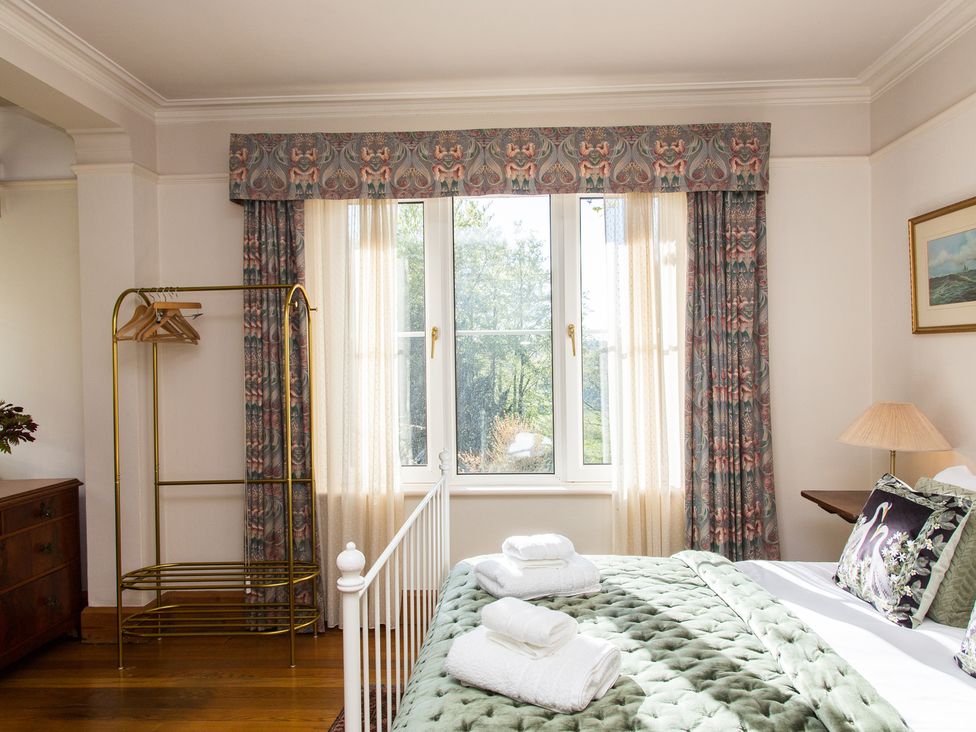 A bedroom with a bed and a clothes rack at Whitebeams Pett Bottom near Stelling Minnis