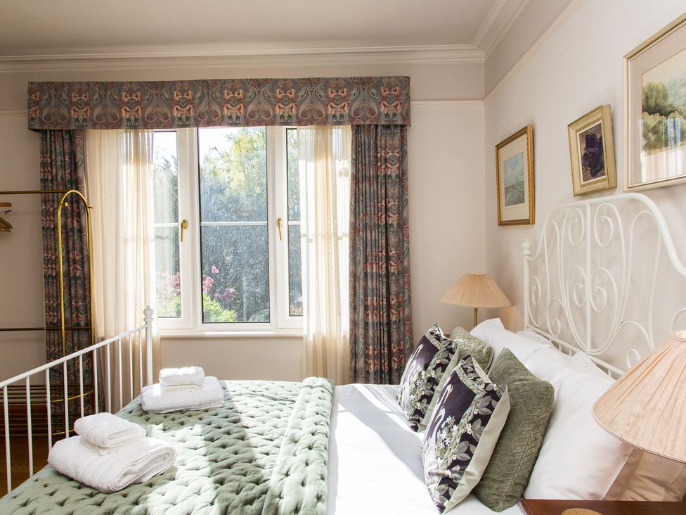 A bedroom with a bed and window at Whitebeams in Pett Bottom near Stelling Minnis