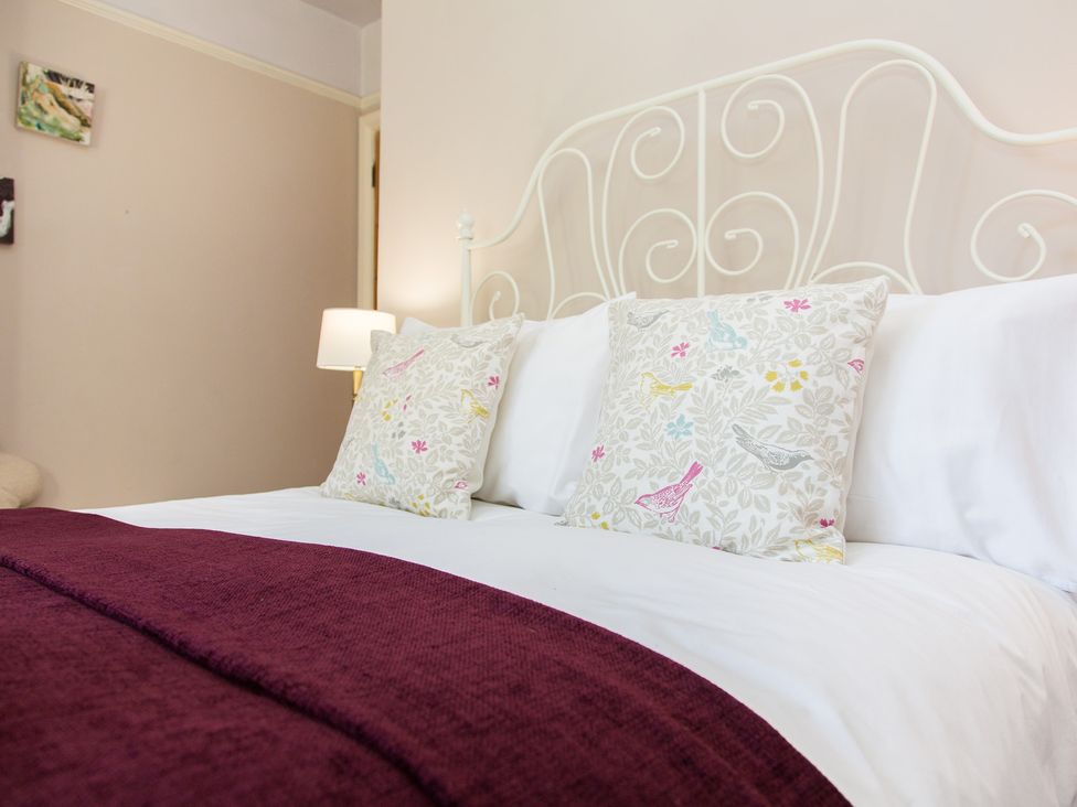 A bed with pillows and a lamp at Whitebeams, Pett Bottom near Stelling Minnis