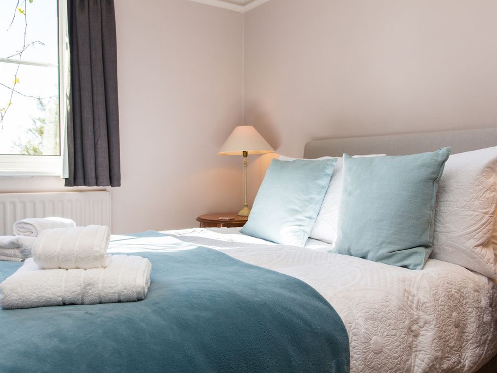 A bedroom with a bed and bedside table at Whitebeams in Pett Bottom near Stelling Minnis